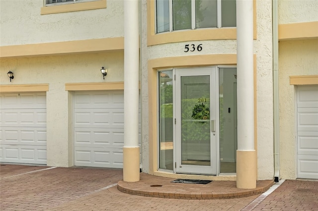 view of exterior entry with a garage