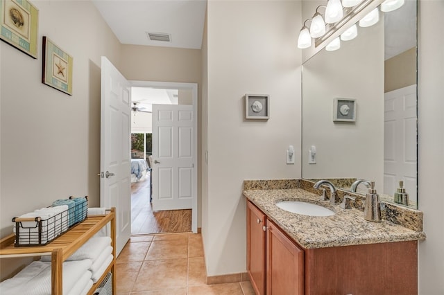 bathroom with hardwood / wood-style flooring, ceiling fan, and vanity