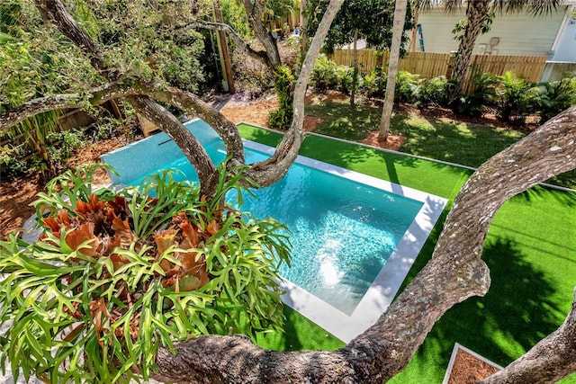 view of pool with a lawn