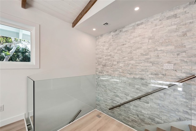 bathroom featuring hardwood / wood-style floors and vaulted ceiling with beams