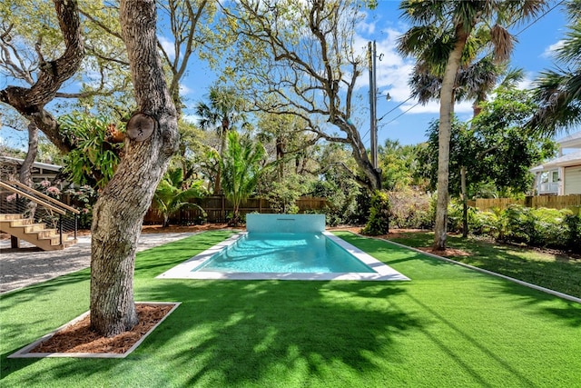 view of swimming pool featuring a lawn