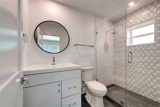 bathroom with vanity, toilet, and walk in shower