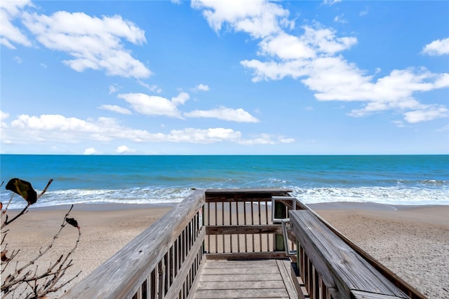 view of home's community with a beach view and a water view