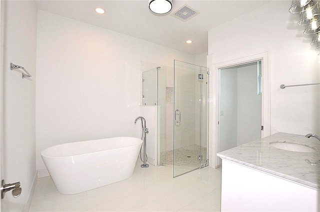 bathroom with vanity, tile patterned floors, and plus walk in shower