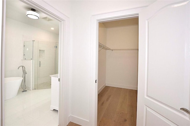 bathroom featuring hardwood / wood-style flooring and separate shower and tub