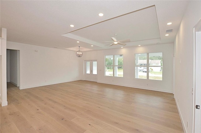 empty room with ceiling fan and light hardwood / wood-style floors