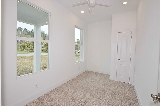 carpeted empty room with ceiling fan