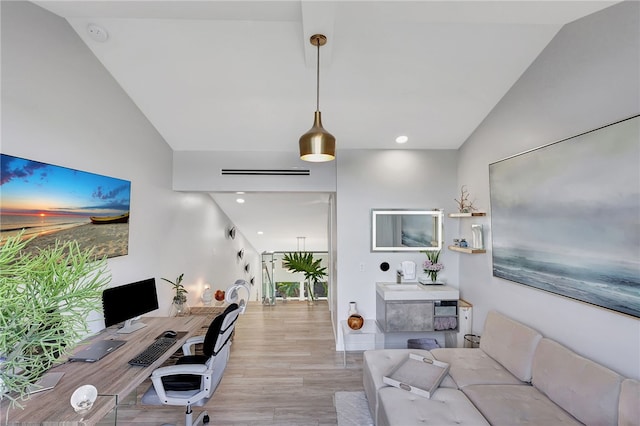 office area with light hardwood / wood-style floors and lofted ceiling