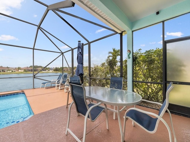 exterior space featuring a water view and outdoor dining area