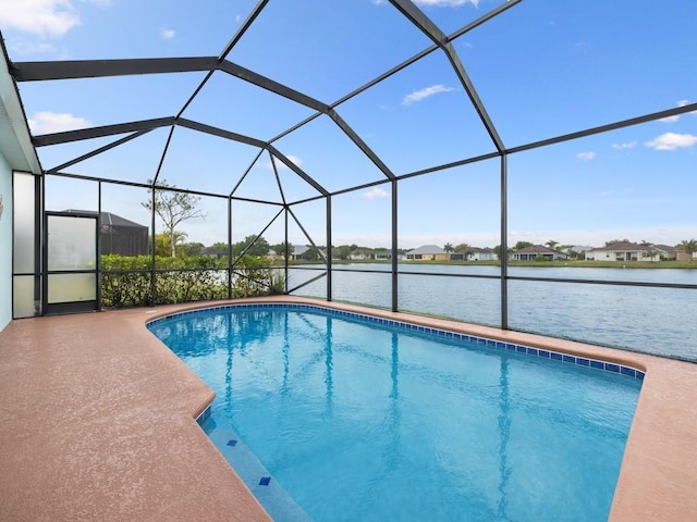 outdoor pool with a lanai, a patio area, and a water view