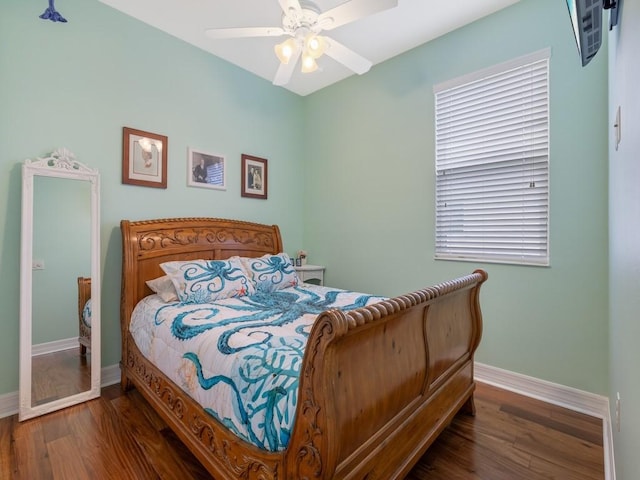 bedroom featuring wood finished floors, ceiling fan, and baseboards