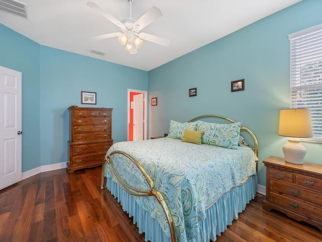 bedroom featuring visible vents, baseboards, and wood finished floors