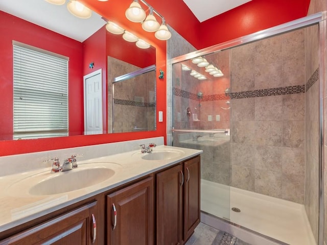 bathroom featuring a sink, a shower stall, and double vanity