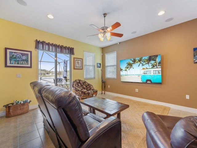living area featuring baseboards, a ceiling fan, and recessed lighting