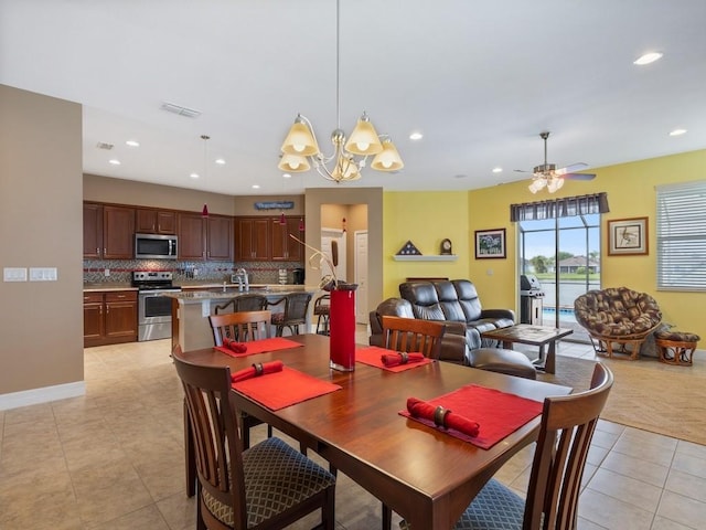 dining area with baseboards, recessed lighting, light tile patterned floors, visible vents, and ceiling fan with notable chandelier