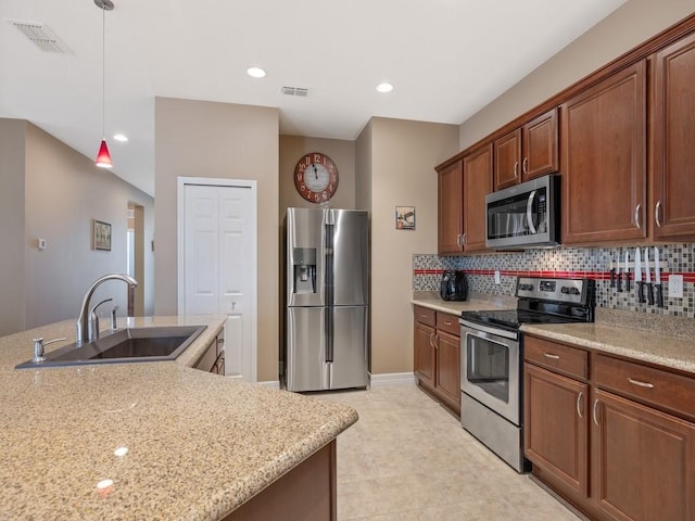 kitchen featuring a sink, visible vents, decorative backsplash, and stainless steel appliances