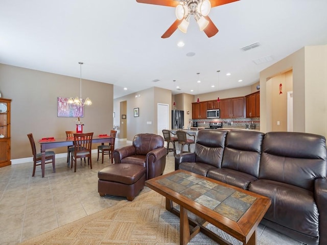 living room with ceiling fan with notable chandelier, light tile patterned floors, visible vents, recessed lighting, and baseboards