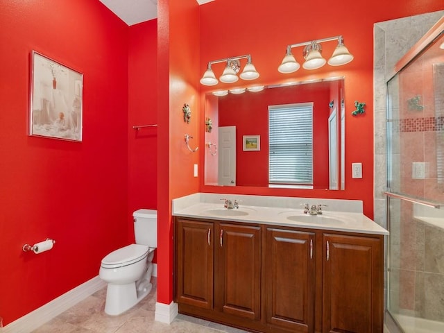 full bath featuring a shower stall, double vanity, a sink, and toilet
