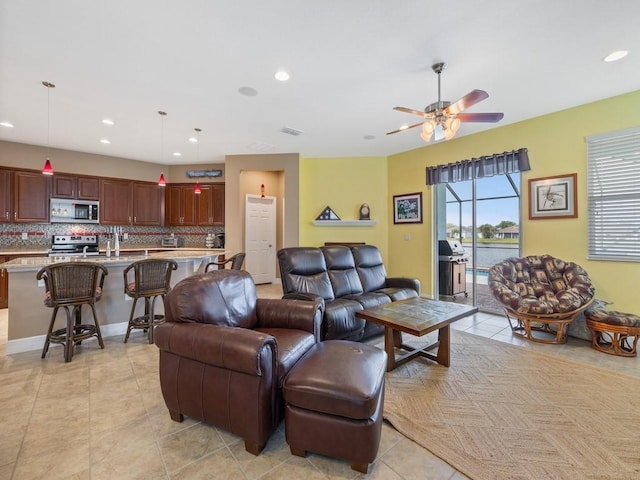 living area featuring visible vents, light tile patterned floors, a ceiling fan, and recessed lighting