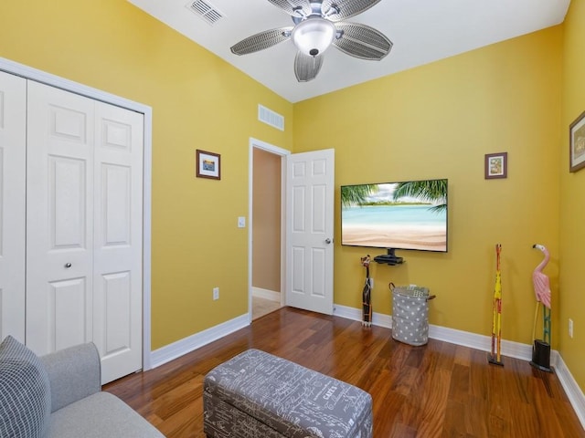 living area with wood finished floors, ceiling fan, baseboards, and visible vents