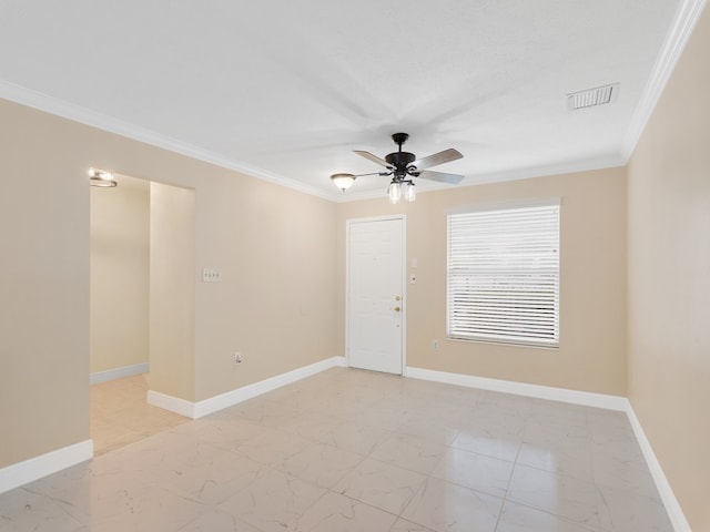 empty room featuring ceiling fan and crown molding