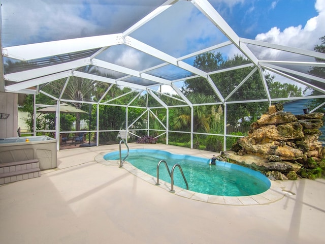 view of pool featuring glass enclosure and a patio