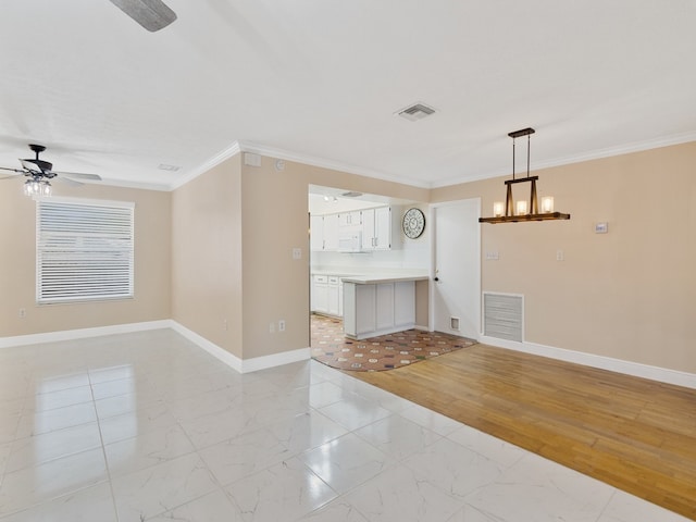 interior space featuring ceiling fan with notable chandelier, light hardwood / wood-style flooring, and crown molding