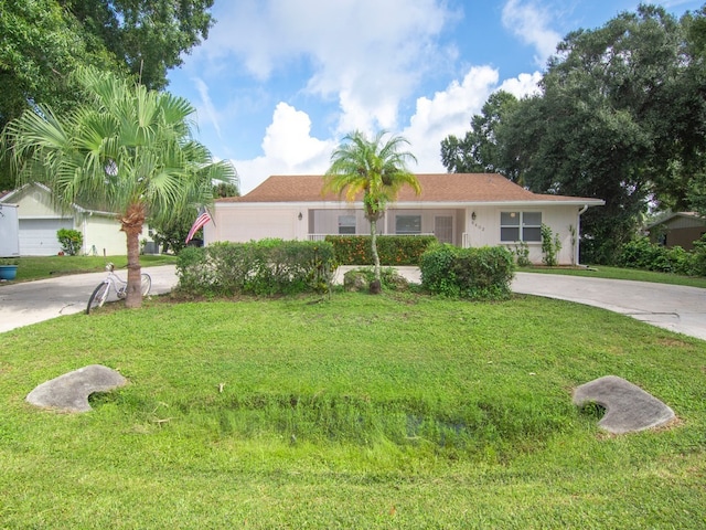 view of front of property with a garage and a front lawn