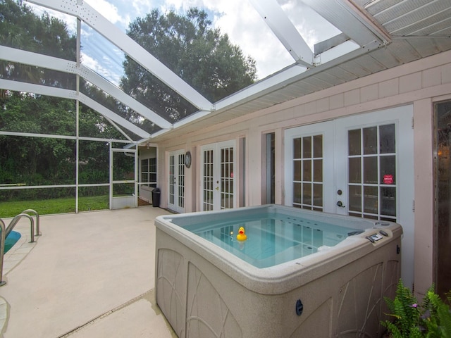 view of swimming pool featuring french doors, glass enclosure, and a patio area