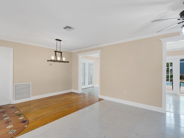 unfurnished room with french doors, ceiling fan with notable chandelier, crown molding, and light hardwood / wood-style flooring