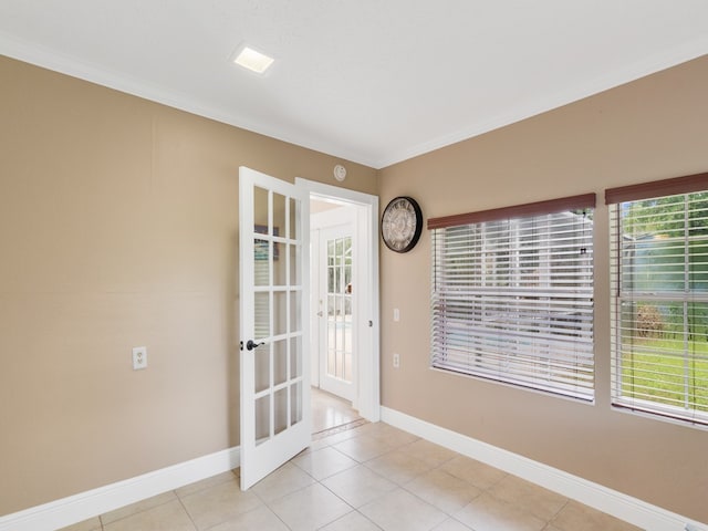 tiled spare room with french doors and crown molding