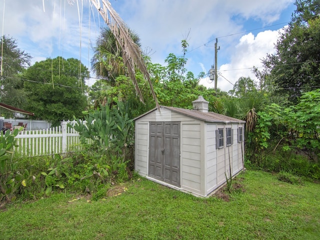 view of outbuilding with a yard