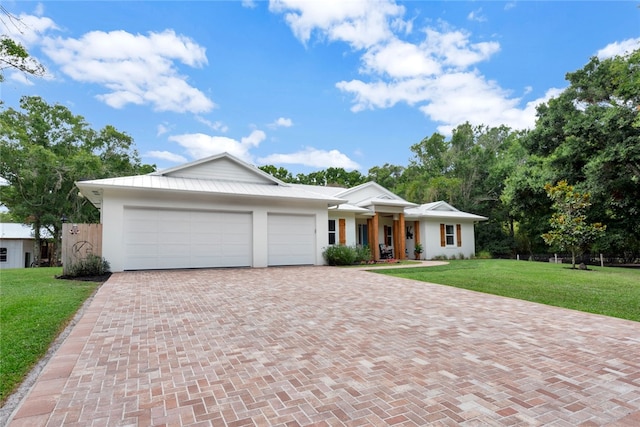 view of front of home with a front lawn and a garage