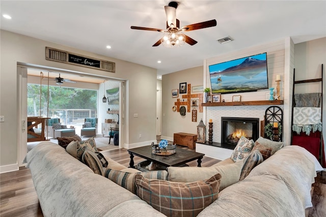 living room featuring hardwood / wood-style floors and ceiling fan