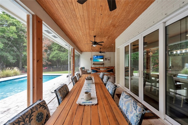 sunroom / solarium with wood ceiling and ceiling fan