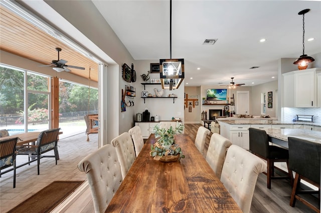 dining room with light hardwood / wood-style flooring and ceiling fan