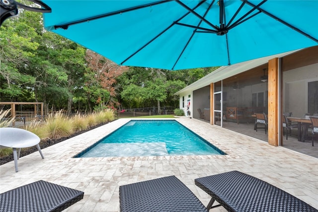 view of pool with a patio, grilling area, and a sunroom