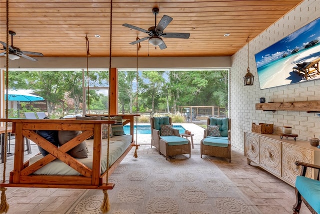 sunroom featuring wooden ceiling and ceiling fan