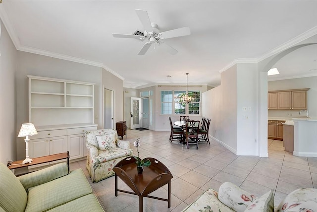 living room featuring sink, light tile patterned floors, ceiling fan with notable chandelier, and ornamental molding