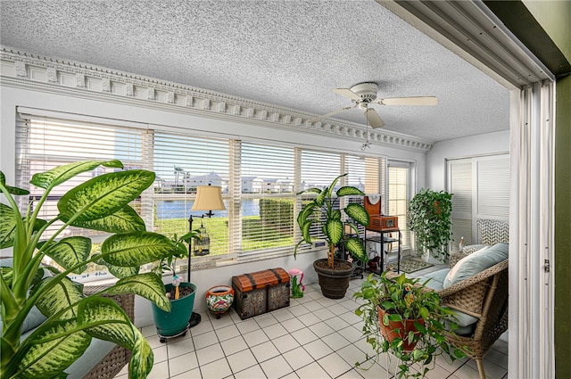 sunroom with a water view and ceiling fan