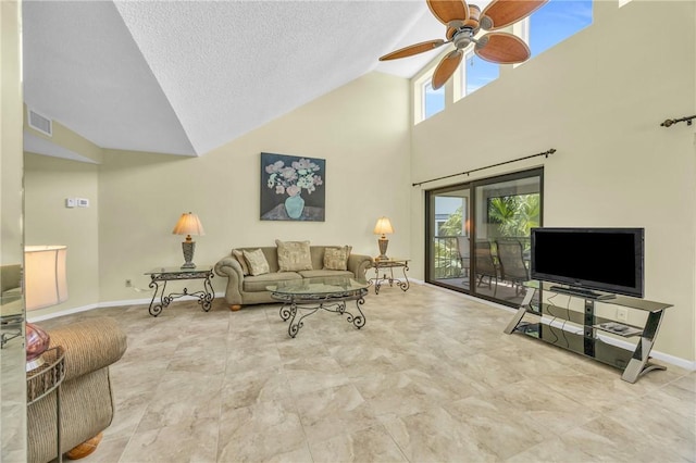 living area with visible vents, plenty of natural light, high vaulted ceiling, and a ceiling fan