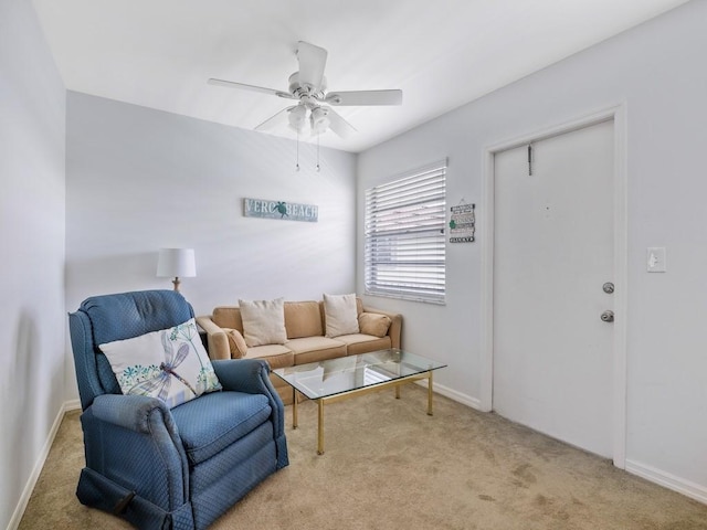 living room with carpet floors, ceiling fan, and baseboards