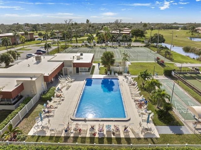 view of swimming pool featuring a water view and fence