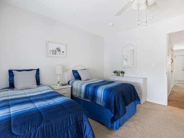 bedroom featuring baseboards, a ceiling fan, and light colored carpet