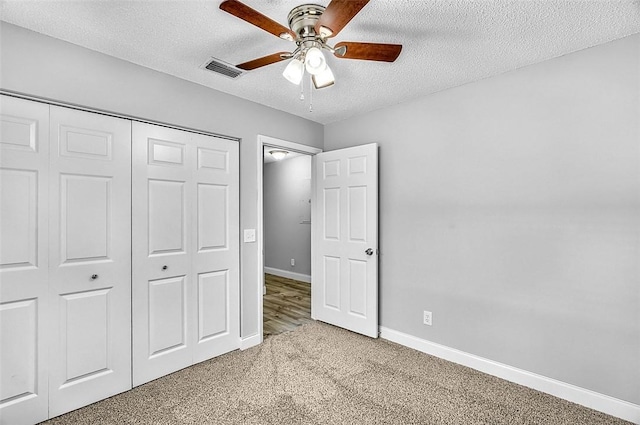 1545 22nd Ave SW, Vero Beach, FL 32962 - unfurnished bedroom with a textured ceiling, carpet, a closet, and ceiling fan