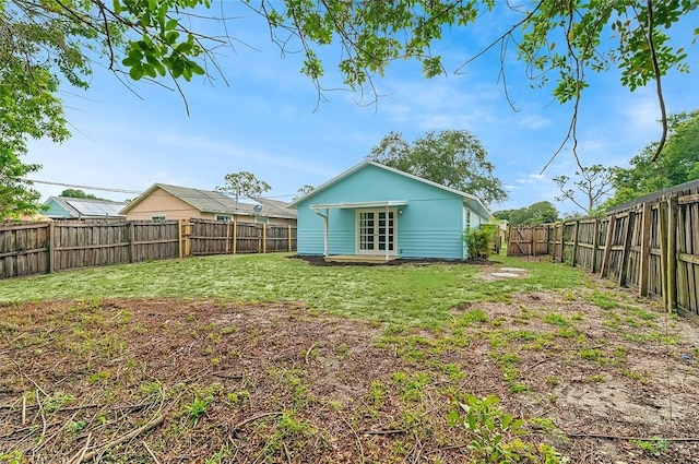 1545 22nd Ave SW, Vero Beach, FL 32962 - rear view of property featuring french doors and a fenced backyard