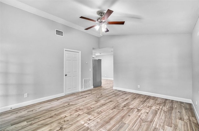 1545 22nd Ave SW, Vero Beach, FL 32962 - empty room featuring ceiling fan, wood finished floors, and vaulted ceiling