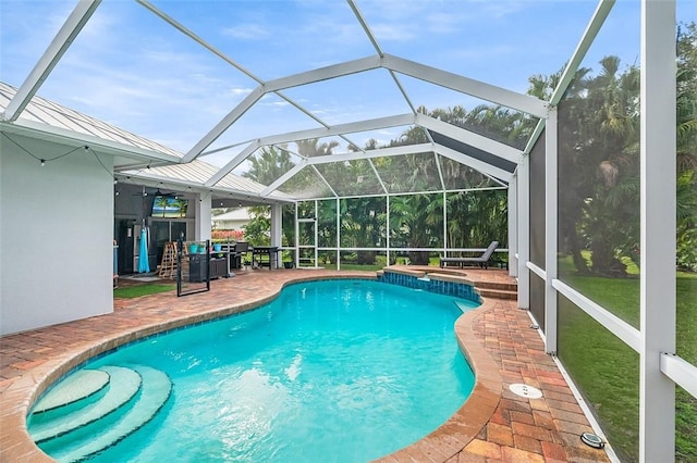 view of swimming pool with a patio and glass enclosure