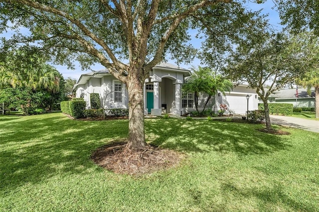 view of front of home with a garage and a front lawn