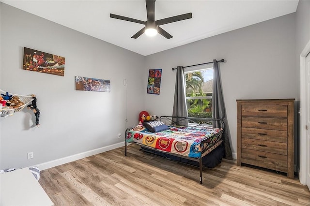 bedroom with ceiling fan and light hardwood / wood-style flooring